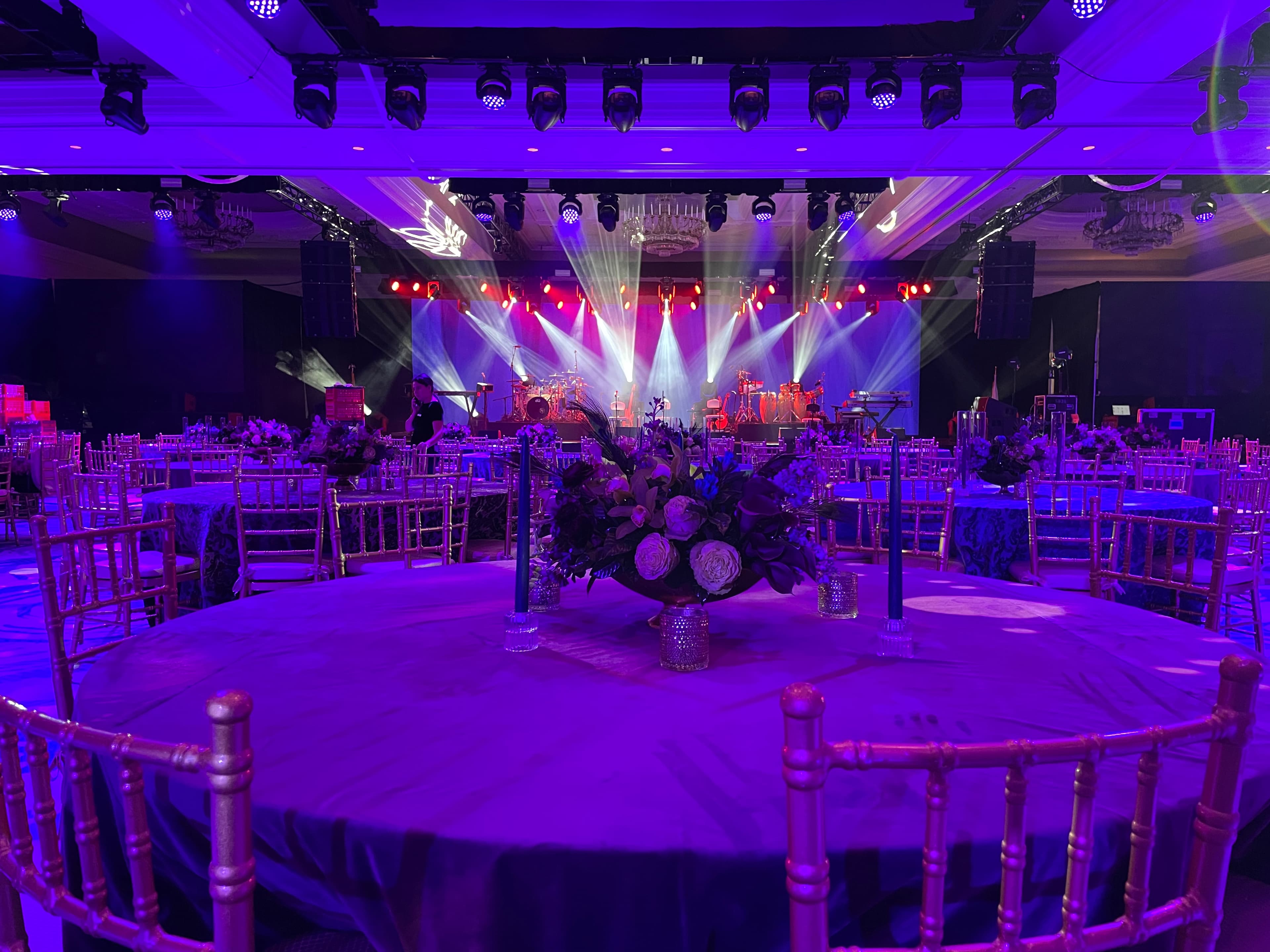 Ayrton moving head fixtures illuminating a corporate event stage with dynamic color wash